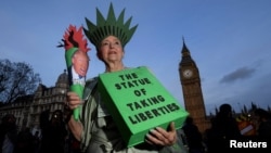 A demonstrator dressed as the Statue of Liberty takes part in a protest against U.S. President Donald Trump in London, Feb. 20, 2017.