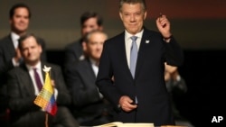 Colombia's President Juan Manuel Santos prepares to sign a modified peace accord with rebels of the Revolutionary Armed Forces of Colombia, FARC, at Colon Theater in Bogota, Colombia, Thursday, Nov. 24, 2016. An original accord ending the half century conflict was rejected by voters in a referendum last month. (AP Photo/Fernando Vergara)
