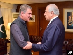Photo released by the Foreign Office shows Pakistan's Foreign Minister Shah Mehmood Qureshi (L) receiving U.S. envoy Zalmay Khalilzad at the Foreign Ministry in Islamabad, April 5, 2019.