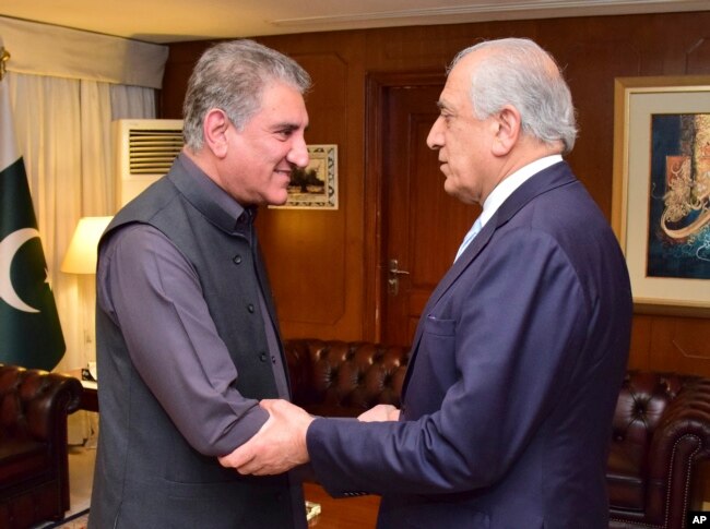Photo released by the Foreign Office shows Pakistan's Foreign Minister Shah Mehmood Qureshi (L) receiving U.S. envoy Zalmay Khalilzad at the Foreign Ministry in Islamabad, April 5, 2019.