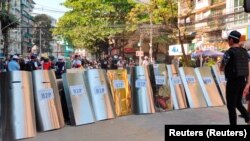 Myanmar, Yangon, Protesters set up a makeshift shield formation in preparation for potential clashes