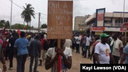 "Oui à l'alternance, non à la dictature" peut-on lire sur un panneau d'une manifestante dans les rues de Lomé, au Togo, le 4 octobre 2017. (VOA/Kayi Lawson)