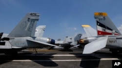 U.S. military aircraft sit on the flight deck of the USS Carl Vinson aircraft carrier anchored off Manila, Philippines, Feb. 17, 2018. 
