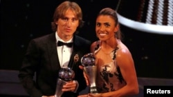 Brazil's Marta, right, who received the Best FIFA Women's player award and Croatia's Luka Modric who received the Best FIFA Men's Player award, pose during the ceremony of the Best FIFA Football Awards in the Royal Festival Hall in London, Sept. 24, 2018.