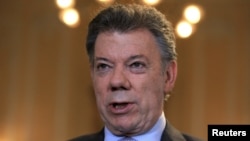 FILE - Colombia's President Juan Manuel Santos speaks during a Reuters interview at the presidential palace in Bogota, April 7, 2015. 