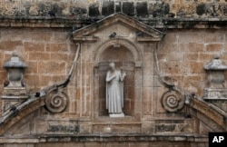 A statue that depicts the 17th-century missionary St. Peter Claver is recessed in an alcove on the facade of the church bearing his name, in Cartagena, Colombia, Aug. 30, 2017.