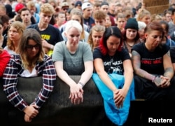 COncertgoers observe a minute of silence before an "anti-racism concert" in Chemnitz, Germany, Sept. 3, 2018.