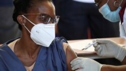 FILE- A healthcare worker receives the COVID-19 vaccine at the Chris Hani Baragwanath Academic Hospital in Soweto, South Africa, February 17, 2021.