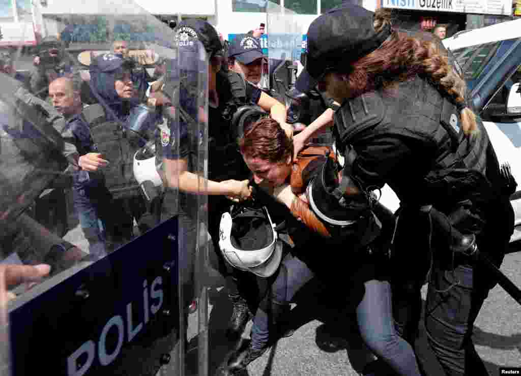 Turkish riot police scuffle with a group of protesters as they attempted to defy a ban and march on Taksim Square to celebrate May Day in Istanbul, Turkey, May 1, 2018.