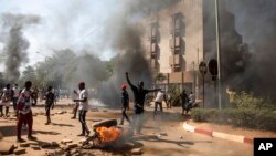 FILE - Protesters take to the streets of Burkina Faso's capital Ouagadougou, Nov. 27, 2021.
