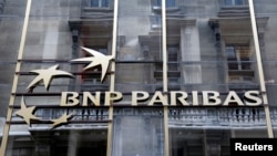 FILE - The logo of BNP Paribas is seen on the bank's building in Paris, May 30, 2014. 