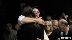 Relatives of Oscar Pistorius hug each other ahead of proceedings at the Pretoria magistrates court on Feb. 22, 2013.
