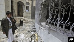 A tribesman checks the damage around the house of Sheik Sadeq al-Ahmar, the head of the powerful Hashid tribe, caused following clashes with Yemeni security forces in Sana'a, Yemen, May 26, 2011