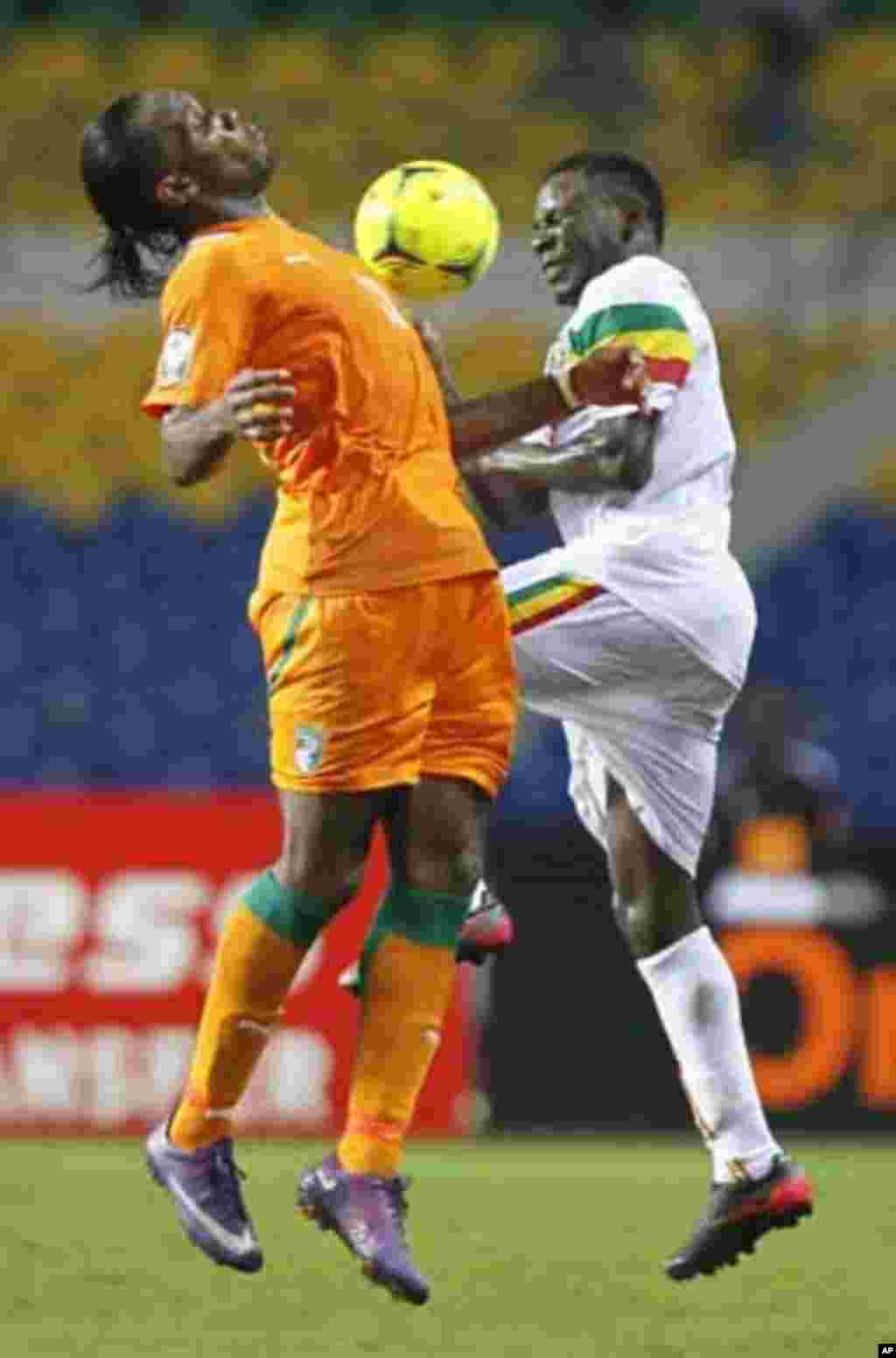 Ivory Coast's Didier Drogba (L) challenges Adama Tamboura of Mali during their African Nations Cup semi-final soccer match at the Stade De L'Amitie Stadium in Gabon's capital Libreville February 8, 2012.