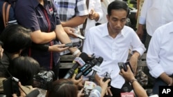Indonesian President Joko Widodo talks to the media during his visit at a reservoir development project in Jakarta, Indonesia, July 22, 2014. 
