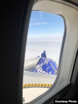 The exploded engine of Southwest Airlines Flight 1380 is seen in the air from a passenger's window, in Philadelphia, U.S., April 17, 2018, in this picture obtained from social media.