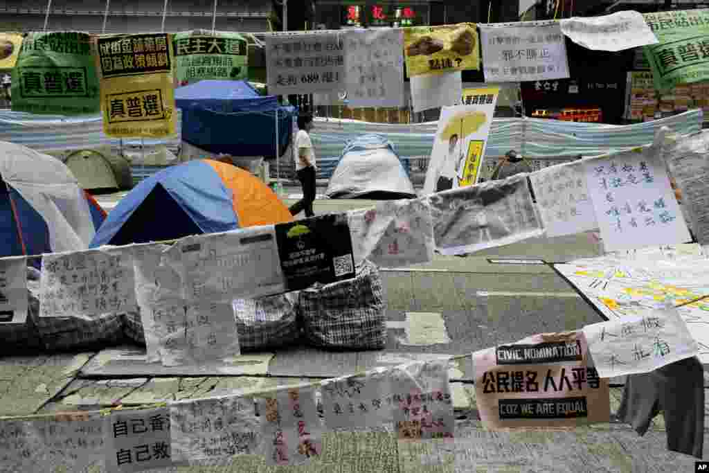 A pro-democracy protester walks in the occupied area of the Causeway Bay district in Hong Kong, Nov. 5, 2014.