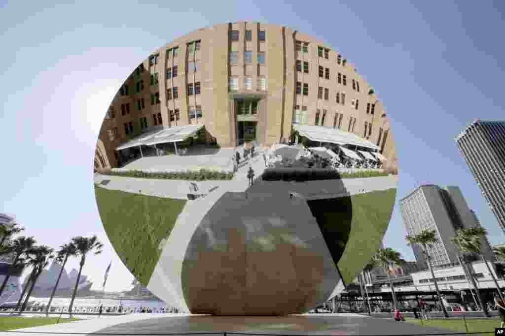 A giant 10 meter (32.8 feet) wide stainless steel disc titled &quot;Sky Mirror&quot;, a work of art by British artist Anish Kapoor, is displayed at the Museum of Contemporary Art in Sydney, Australia. The mirror has convex and concave surfaces creating constantly changing images as the sun and clouds in the sky move as well as people passing by.