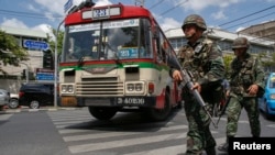 Thai soldiers patrol on a road near an army club during a military coup in Bangkok, May 23, 2014.