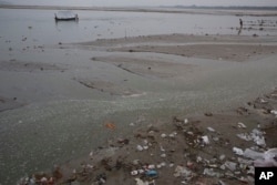FILE - Plastic bags and garbage litter the banks of River Ganges on World Environment Day in Allahabad, India, June 5, 2017.