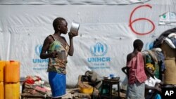 FILE - A South Sudanese refugee girl finishes her porridge, at the Imvepi intake center, where newly-arrived refugees are processed before being transferred to the nearby Bidi Bidi refugee settlement, in northern Uganda, June 9, 2017.