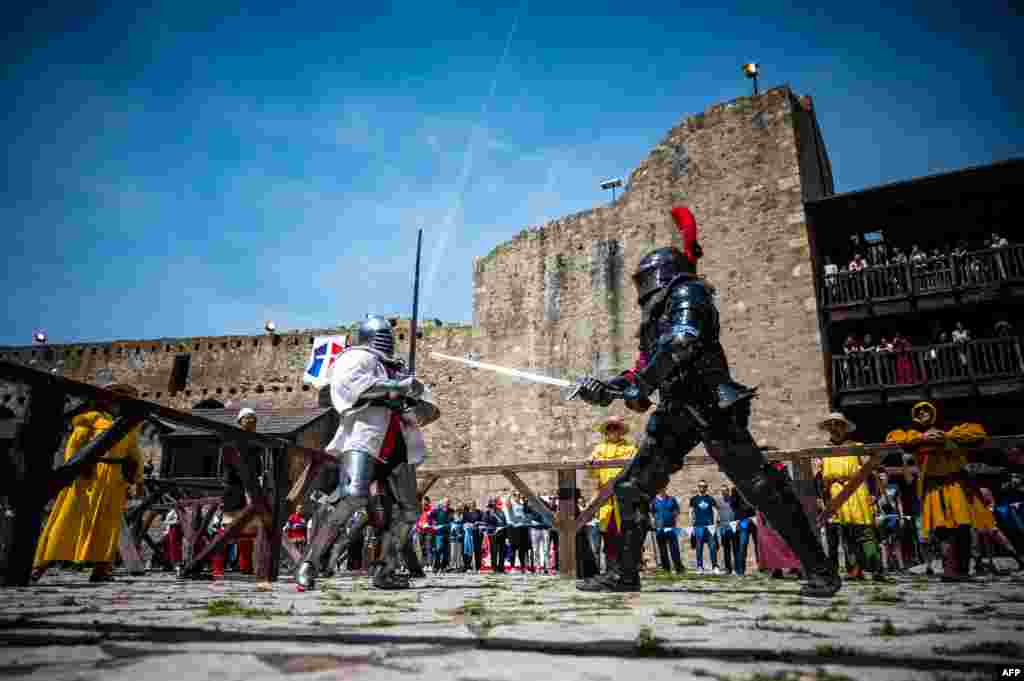 Participants wearing armours fight during the medieval tournament &quot;Battle of the Nations&quot; at the Smederevo fortress, in eastern Serbia, May 4, 2019.