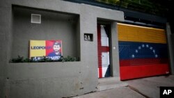 A banner with the image of opposition leader Leopoldo Lopez stands outside of his home in Caracas, Venezuela, Aug. 1, 2017.