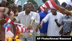 A group of Kenyan muslims burn the U.S. flag following afternoon prayers outside the Sakina Jamia Mosque in the port city of Mombasa, Sept. 14, 2012.