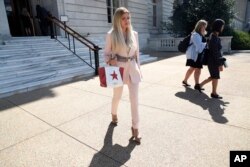 Simona Mangiante Papadopoulos, wife of former Donald Trump campaign adviser George Papadopoulos, leaves the Cannon House Office Building after attending a closed-door meeting with Democrats on the House intelligence committee, July 18, 2018, on Capitol Hill in Washington. George Papadopoulos pleaded guilty last year to lying to investigators about his contacts with people linked to Russia during the campaign.