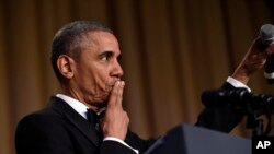 Former President Barack Obama concludes his remarks -- with a "mic drop" -- after speaking at the White House Correspondents' Association dinner at the Washington Hilton in Washington, Saturday, April 30, 2016. (AP Photo/Susan Walsh)