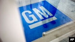 FILE -The logo for General Motors decorates the entrance at the site of a GM information technology center in Roswell, Georgia.