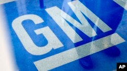 FILE -The logo for General Motors decorates the entrance at the site of a GM information technology center in Roswell, Georgia.