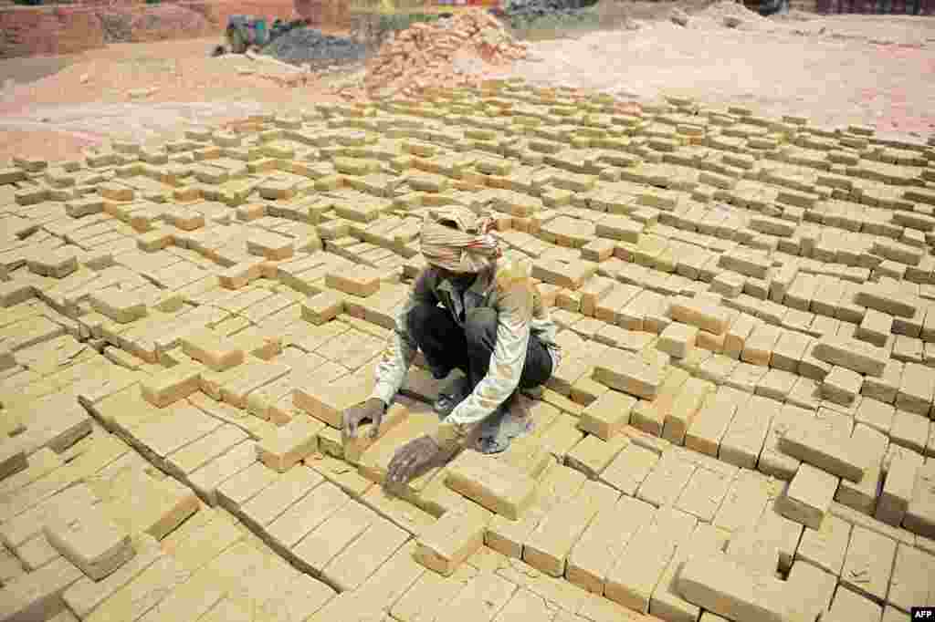 A laborer works at a brick kiln in Allahabad, India.