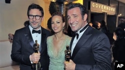 From left, Michel Hazanavicius with the award for best director for 'The Artist,' Berenice Bejo and Jean Dujardin with the award for best actor in a leading role for 'The Artist' at the Governors Ball following the 84th Academy Awards, in the Hollywood se