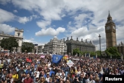 FILE - Protestors hold banners in Parliament Square during a 'March for Europe' demonstration against Britain's decision to leave the European Union, central London, Britain, July 2, 2016.