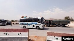 12일 두마서 대피한 반군들과 그의 가족들을 태운 버스가 시리아 다마스쿠스의 와피딘 캠프 입구에 도착해 있다. 