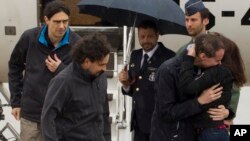 This photo made available by Presidencia del Gobierno on Sunday, May 8, 2016, the three freed Spanish journalists Antonio Pampliega, right, Jose Manuel Lopez, left, and Angel Sastre, arrive at the Torrejon military airbase in Madrid, Spain. 