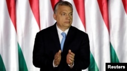 Hungarian Prime Minister Viktor Orban applauds as he presents the program of his Fidesz party for European Parliament elections in Budapest, Hungary, April 5, 2019.