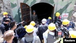 FILE - Journalists look around the third tunnel of Punggye-ri nuclear test ground before it is blown up during the dismantlement process in Punggye-ri, North Hamgyong Province, North Korea, May 24, 2018. Pyongyang did not allow international inspectors at the site.