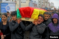 Mourners carry coffin of Yakup Sinbag, a civilian who was killed during the clashes between Turkish security forces and Kurdish militants, in Silvan in the southeastern Diyarbakir province, Turkey, Nov. 10, 2015.