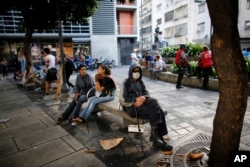 An anti-government demonstrators rest at a square in Chacao, Caracas, Venezuela,July 30, 2017.