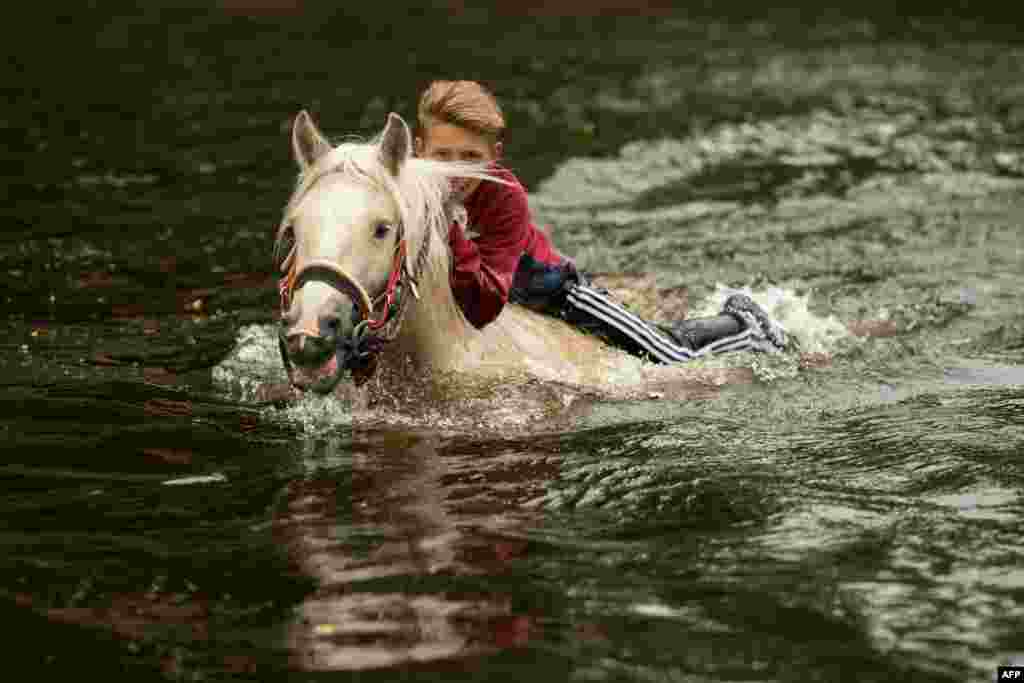 A young boy&nbsp; washes a horse in the River Eden on the second day of the annual Appleby Horse Fair, in the town of Appleby-in-Westmorland, northwest England.