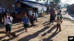 Myanmar ethnic Kachin refugees gather as school children go to school, at their residence at Wine Maw Refugee Camp in Kachin State (AP Photo/Khi