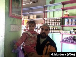 Othman Taha keeps a picture of his son, Abdulrahman hanging in his small grocery. He says Abdulrahman was murdered under IS rule when he was 3 years old.