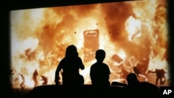 Children atop the family car at the Galaxy Drive-In Theatre in Ennis, Texas