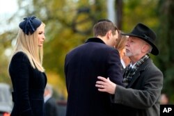 Jared Kushner, center, and Ivanka Trump, left, greet Tree of Life Rabbi Jeffrey Myers, right, as they arrive with President Donald Trump and first lady Melania Trump outside Pittsburgh's Tree of Life Synagogue in Pittsburgh, Tuesday, Oct. 30, 2018. (AP Ph