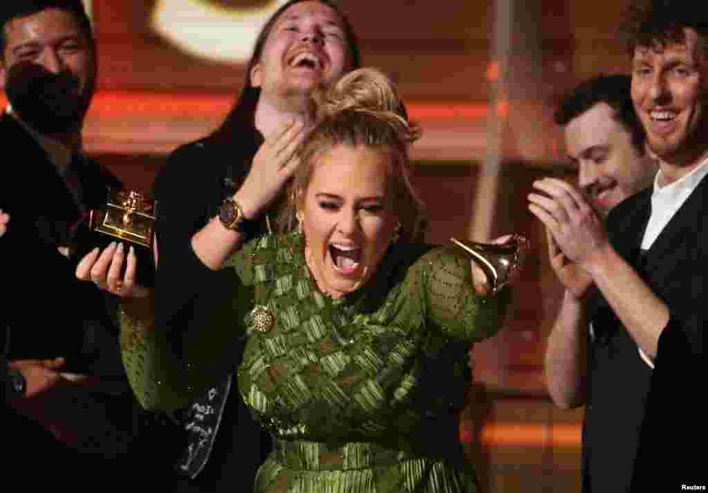 Adele breaks the Grammy for Record of the Year for &quot;Hello&quot; at the 59th Annual Grammy Awards in Los Angeles, California, Feb. 12, 2017.