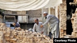 Earthquake victims are seen digging through rubble in an image posted on the campaign homepage of GlobalGiving.org. (Courtesy - GlobalGiving)