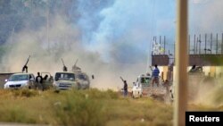 Smoke rises during clashes between irregular forces loyal to former Libyan army chief of staff General Khalifa Hafter and Islamist militants, in the eastern city of Benghazi, June 2, 2014.