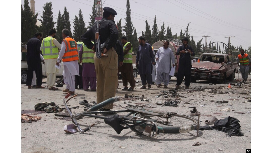 Pakistani security personnel visit the site of bombing in Quetta, Pakistan, July 25, 2018.
